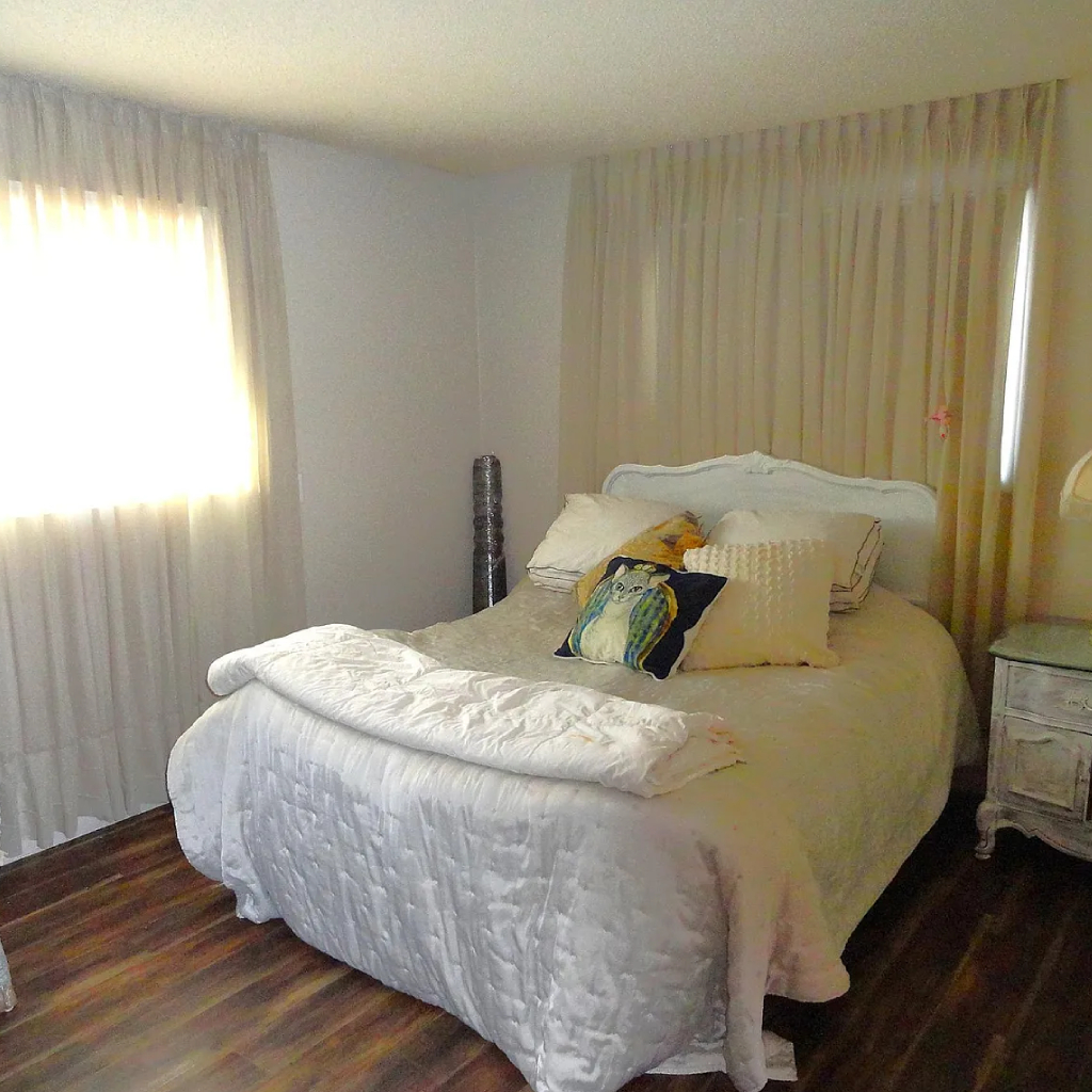 Warm, well-lit interior of a common living room in a small, home-like memory care unit.