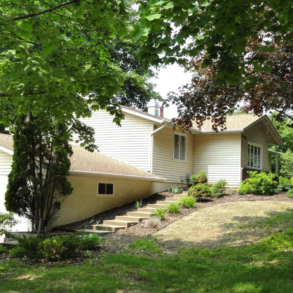 Warm, well-lit interior of a common living room in a small, home-like memory care unit.
